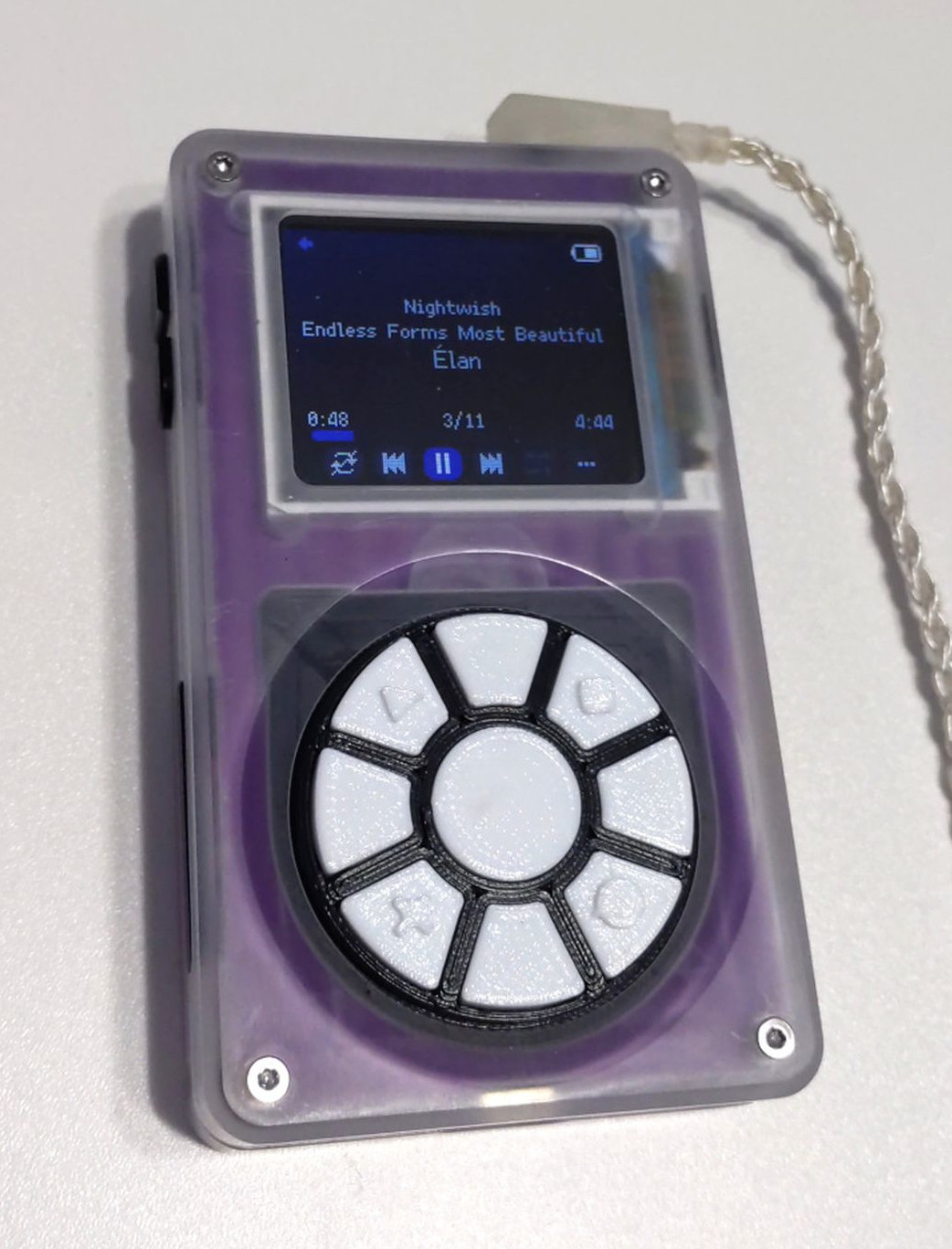A Tangara music player with a modified faceplate, replacing the touchwheel with a set of radial buttons fitting into the same space.